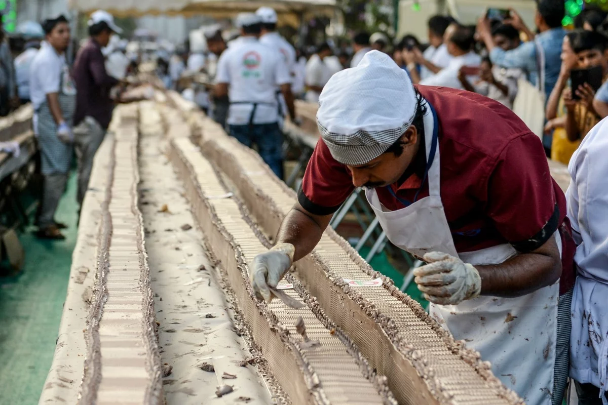 Hundreds of bakers and chefs in southern India came together on Wednesday to create what they said is the world’s longest cake