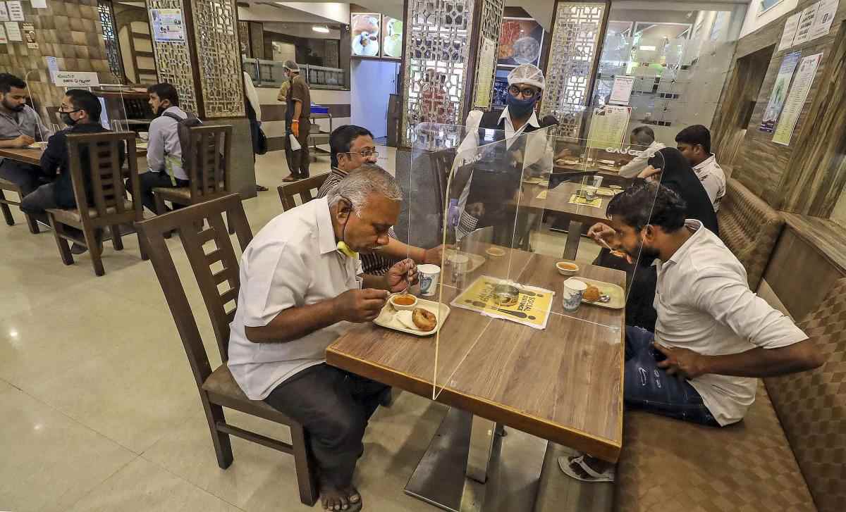 Some restaurants opened but waiters, in scenes that could be straight from a futuristic sci-fi film, were in face shields and the customers, at tables placed a safe distance from each other, in masks till the food arrived