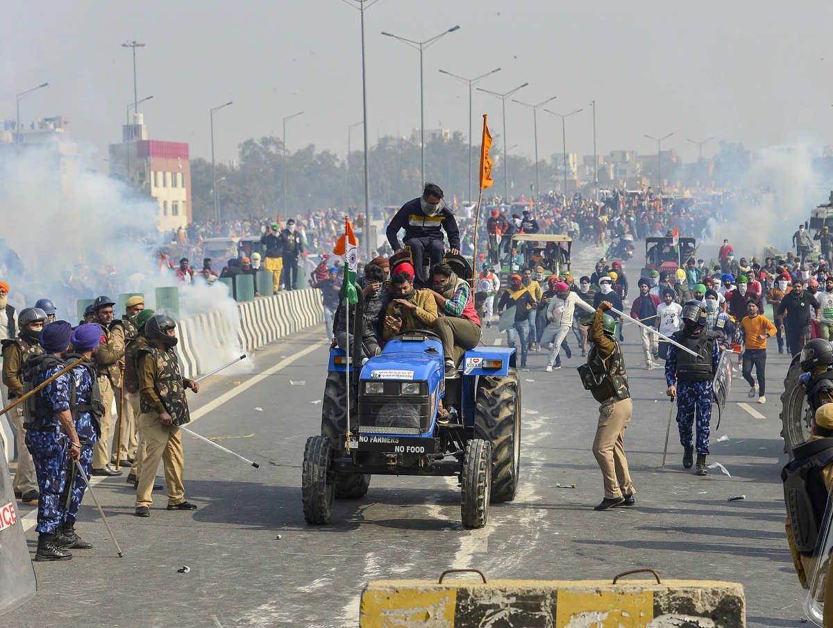 Police resort to lathicharge and use teargas to disperse protesting farmers who were attempting to break barricades at Ghazipur border during their tractor march on Republic Day in New Delhi.