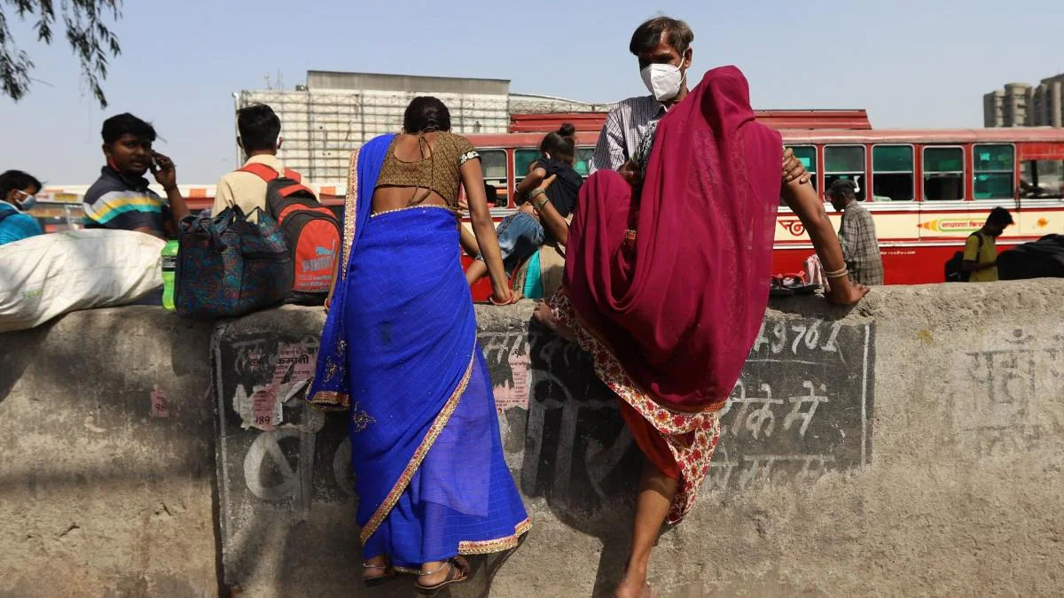 Migrant workers arrive at a bus station in Kaushambi, Uttar Pradesh, to travel back to their hometowns after a lockdown till April 26 was announced in the national capital in the wake of rising Covid cases