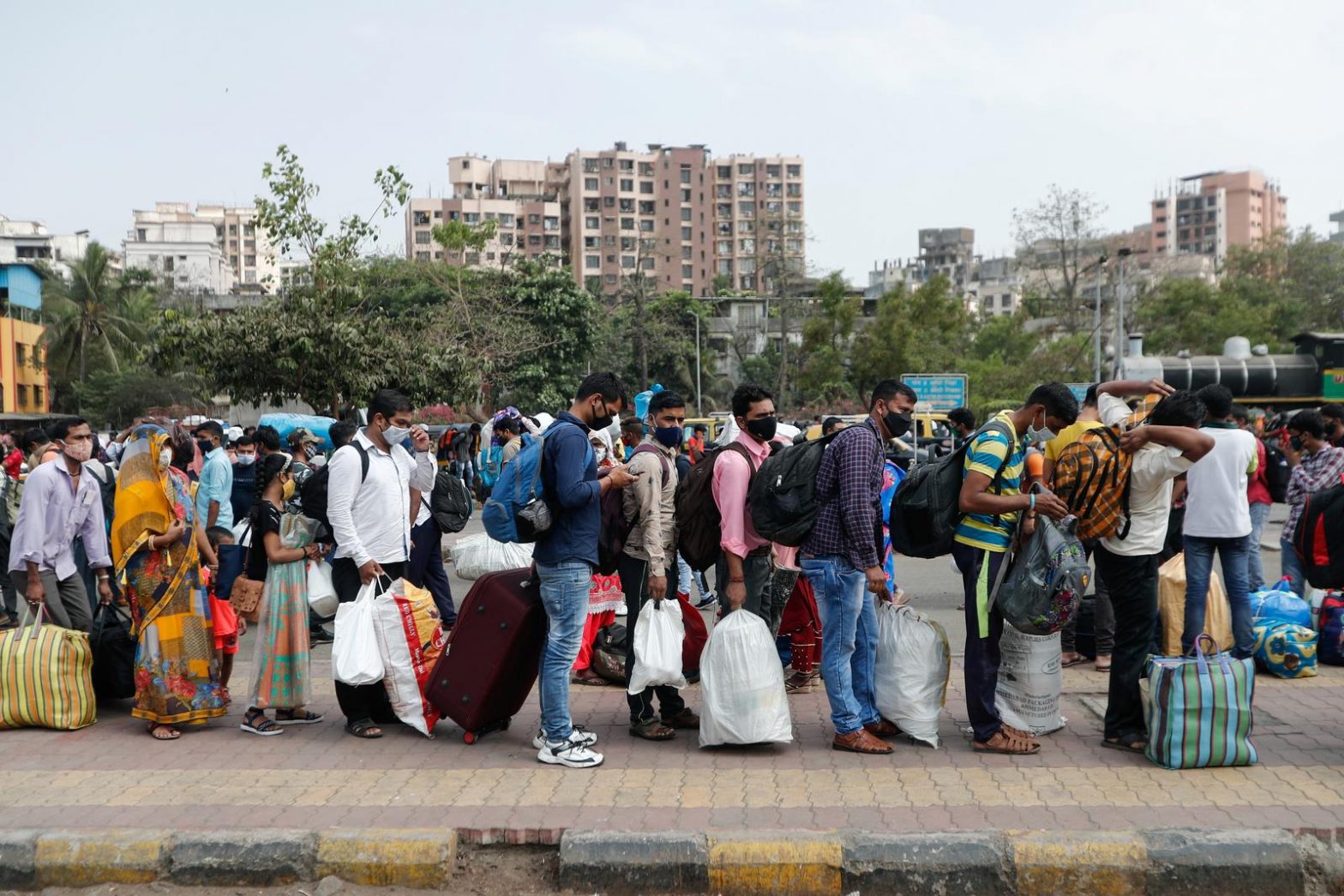 People wearing protective masks stand in line at a railway station amidst the spread of the coronavirus disease (COVID-19) in Mumbai, India, 9 April, 2021.